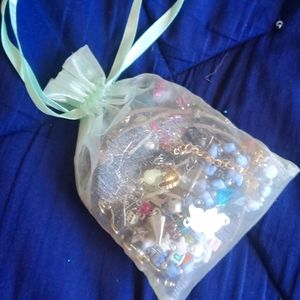 Bag of bracelets, rings, earrings and necklaces.